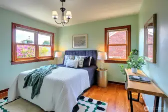 The second bedroom on the main level has natural light from two sides and views to a spacious rear garden.