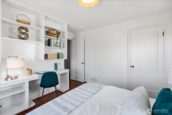Main floor bedroom with closet and built in desk