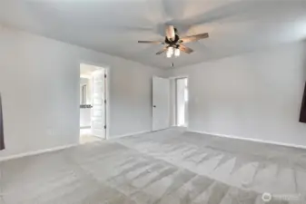Primary bedroom with ceiling fan.