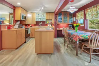 Kitchen features large island with storage, two stylish display cabinets and a handy work station.