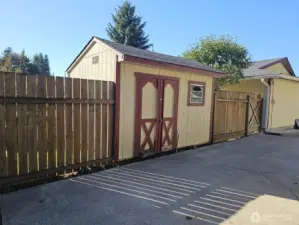 Shed at the end of the driveway. Gate leads to back yard.