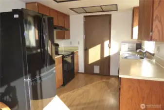 Another view of the kitchen with new frig.