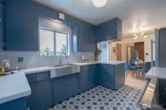 Kitchen boasts porcelain tile floors, quartz counter, new stainless steel appliances and large apron sink! Check out the original restored details!