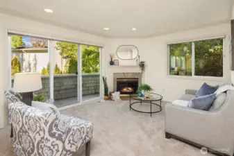 Inviting formal living room off the entry with gas fireplace and private balcony