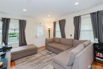 The living room has lots of windows bring in lots of natural light.