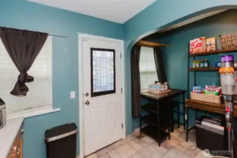 The door goes out the back yard and Detached utility room and bonus room.