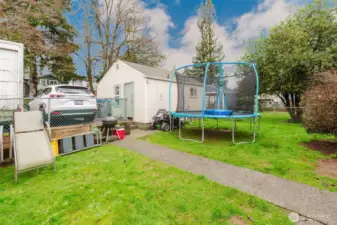 The backyard and detached building.