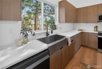 The kitchen sink is positioned to capture a pleasant view, bringing in natural light and a welcoming outlook