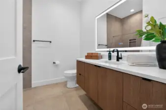 Full bathroom showcasing high ceilings and floating cabinetry for a refined, modern aesthetic