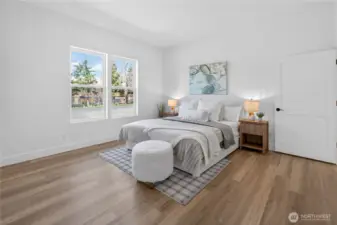 Generous primary suite featuring a walk-in closet and an en-suite bathroom