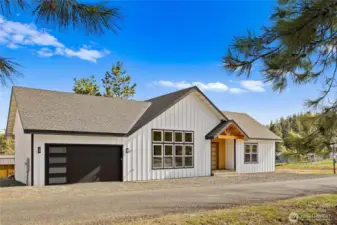 Black garage doors complement the home’s modern exterior palette for a cohesive architectural look