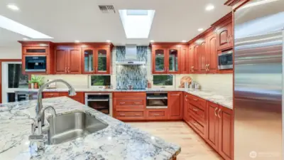 The kitchen feathers a extra large Sub Zero refrigerator and freezer, a Miele wall over and a Miele Steam oven, GE Profile Microwave, TRUE separate Ice maker and beverage cooler.