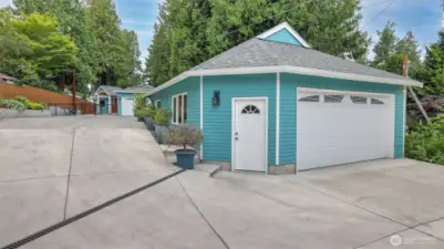 Detached 800 square foot garage has a kitchenette and 3/4 bath, tankless water heater and hot and cold spigots to wash cars. The building has ADU potential.