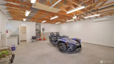 A shot of the detached garage interior. Heated floor, attic space, tankless water heater. A generator is shared between this garage and the main home.