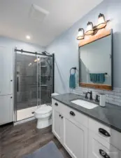 Bathroom with walk in shower, nice cabinets an quartz counter tops.
