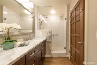 This spa-like 3/4 bath has been tastefully remodeled with Quartzite counters, glass shower,