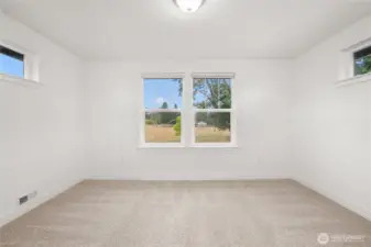Upstairs bonus room alcove with large windows showcasing views of grazing cows across the street and a stunning backdrop of Mount Rainier.
