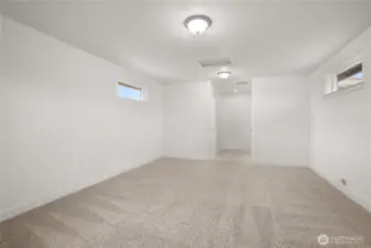 Upstairs bonus area includes a 3/4 bath and additional storage space, offering versatility for a home office, guest suite, or recreation room.