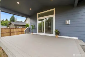 Covered deck with recessed lighting, offering a seamless indoor-outdoor flow for year-round enjoyment.