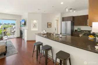 Spacious kitchen with gas range, abundance of cabinets, stainless appliances, and breakfast bar.