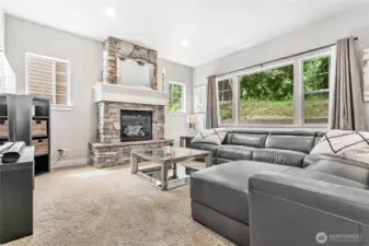 Main living room, note large window and gas fireplace