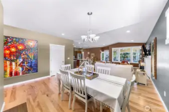 Open concept living and dining area, with lake views through the custom sunroom off the living room