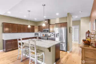 Spacious kitchen with plenty of storage and counter space, tons of storage. View from dining space thru kitchen to hallway to main level bedrooms, guest bath and utility room
