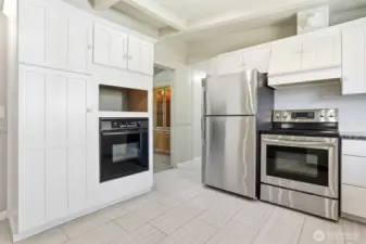 Updated kitchen with tile floors, stainless appliances, eating bar and opens to family room, living room and dining room