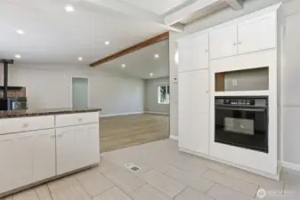 Updated kitchen with tile floors, stainless appliances, eating bar and opens to family room, living room and dining room