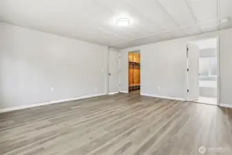 Master bedroom suite with vaulted ceilings, new LVP flooring, walk in closet and updated 4 piece bathroom