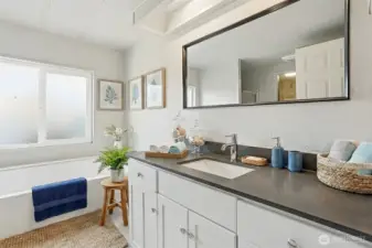 Master bedroom suite with vaulted ceilings, walk in closet and updated 4 piece bathroom - virtually staged photo