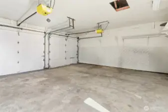 Attached 2 car garage with a separate workshop space