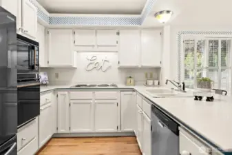 Kitchen is U-shaped and visible from nook and family room.