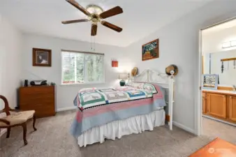 Primary suite with full bath, walk-in closest and ceiling fan.