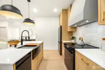 Beautiful chef's kitchen with custom cabinets and hood.