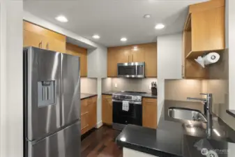This updated and functional kitchen boasts fresh hardwood flooring, brand new appliance packages, and stunning quartz counters. It's a perfect blend of style and practicality, ready to inspire your culinary adventures.
