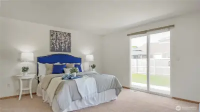 Spacious Primary Bedroom w/ Sliding Glass Door To Backyard. En-Suite and WIC To The Left