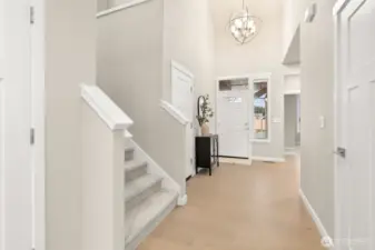 Entryway looking back at entry door with decorative glass panels that allow natural light to shine through!