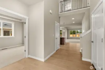 This inviting home interior showcases hardwood flooring, contemporary details and white millwork throughout.
