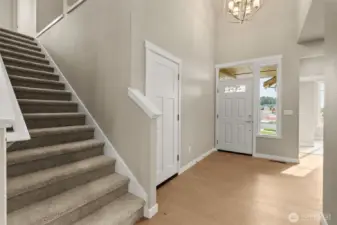Hardwood floors extend from entry way through hallway to kitchen and dining room