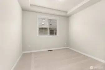 Den/ office or 3rd bed option on main level with tray ceilings and big window. It can also be used as a 3rd bed option.
