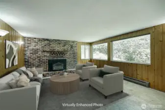 The lower level fireplace includes a wood burning fireplace insert.  Big picture windows offer views of the backyard landscape.