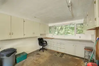 The 3rd garage bay is set up as a shop with built in work bench and storage cabinets.