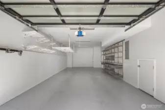 Two-car tandem garage with custom flooring & storage.