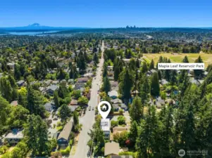 Aerial view of home showcasing rooftop deck, views of Mount Rainier & close proximity to Maple Leaf Reservoir Park.