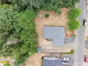 Spacious, nearly half-acre flat lot with room for RV parking, gardening, and entertaining around the fire pit.