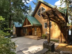 Expansive back patio and covered entry, including arbor.