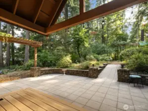 Large, covered rear porch looking out towards backyard and amazing play structure and potting shed.