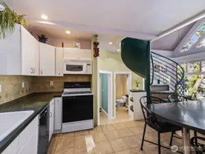 Spiral staircase leads up to loft and access to rooftop deck.
