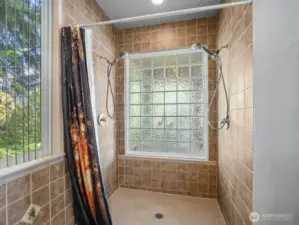 Primary shower with twin shower heads.